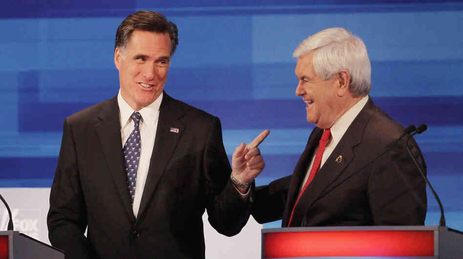 Former Speaker of the House Newt Gingrich and former Massachusetts Gov. Mitt Romney chat after finishing a GOP debate in Sioux City, Iowa, earlier this month. 