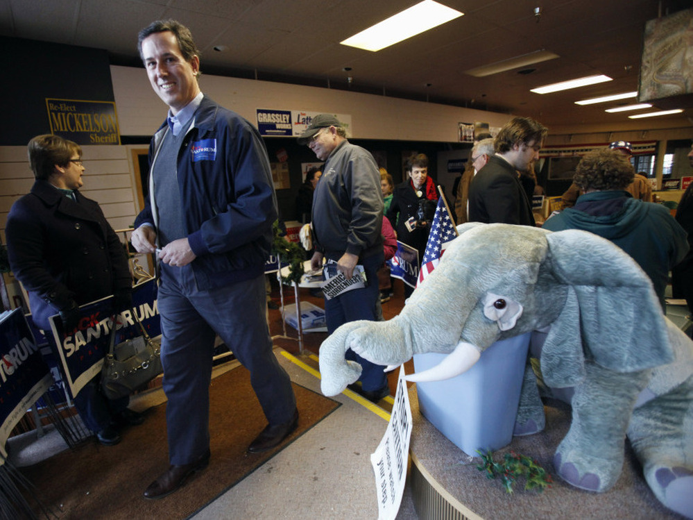 Former Pennsylvania Sen. Rick Santorum leaves the Fort Dodge, Iowa, GOP headquarters after speaking Tuesday.
