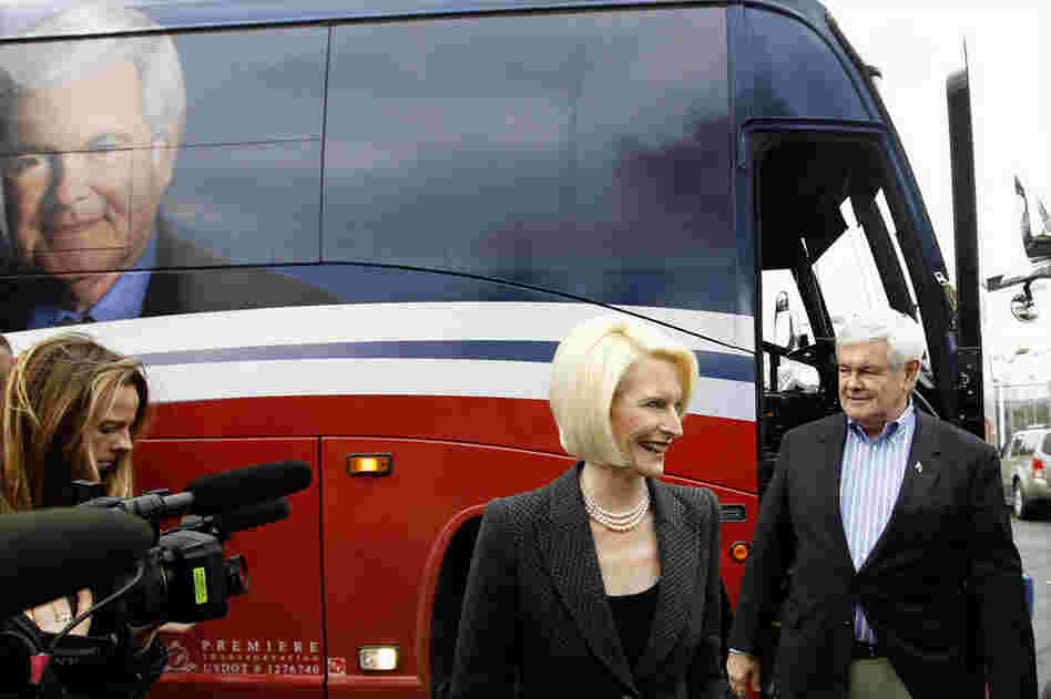 Former House Speaker Newt Gingrich and his wife, Callista, walk off his campaign bus during a Dec. 27 stop at the Dubuque Golf and Country Club in Dubuque, Iowa. 