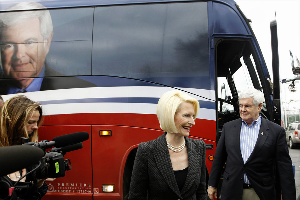Former House Speaker Newt Gingrich and his wife, Callista, walk off his campaign bus during a Dec. 27 stop at the Dubuque Golf and Country Club in Dubuque, Iowa. 