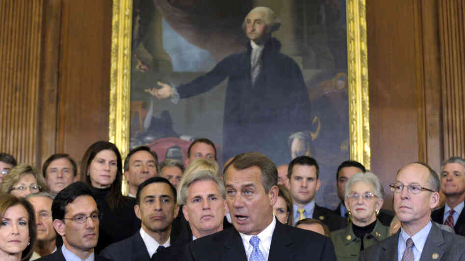 House Speaker John Boehner, surrounded by Republican House members, speaks during a news conference in Washington last week. The House initially rejected a plan to extend a tax cut for two months to buy time for talks on a full-year renewal. It later compromised — a rare event in 2011.