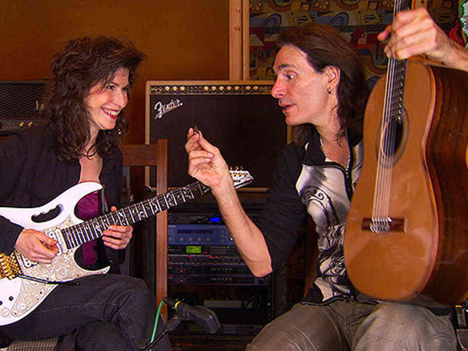 Sharon Isbin (left) and Steve Vai switch axes. 