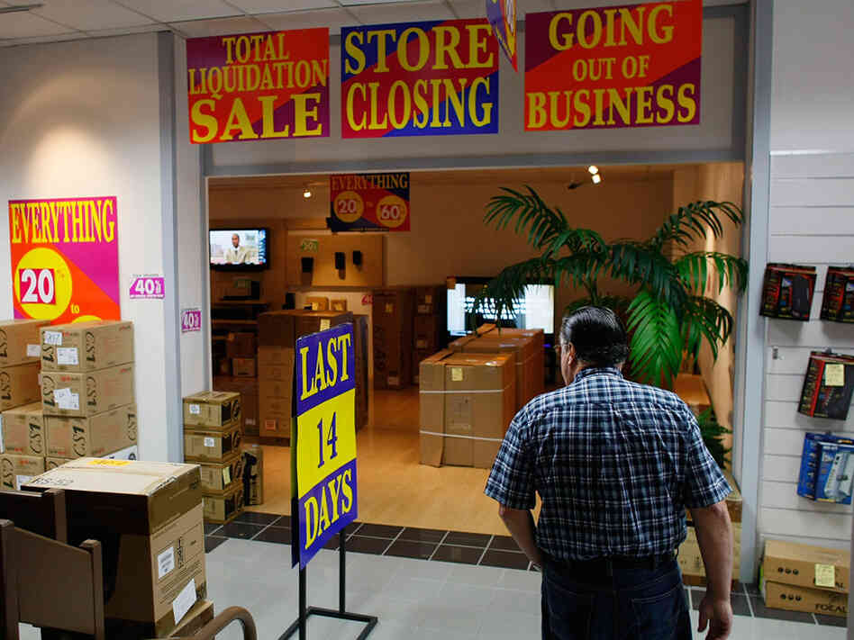 A shopper looks for bargains at an electronic store holding a going-out-of-business sale. A shopper looks for bargains at an electronic store holding a going-out-of-business sale.