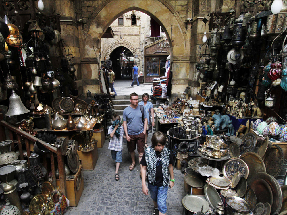 Foreign tourists stroll through the Khan el-Khalili market in Cairo.
