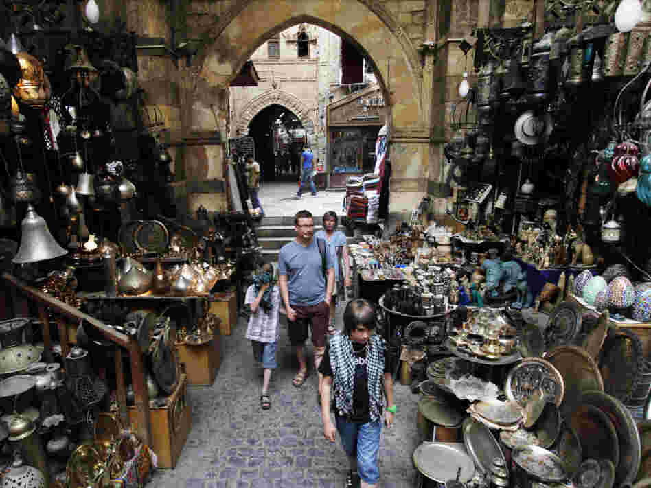 Foreign tourists stroll through the Khan el-Khalili market in Cairo.