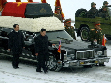 Kim Jong Un, center, walks with his hand on the limousine bearing his father Kim Jong Il's body earlier today in Pyongyang. Kim Jong Un, center, walks with his hand on the limousine bearing his father Kim Jong Il's body earlier today in Pyongyang.