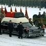 This photo provided by Korean Central News Agency (KCNA) shows Kim Jong Un, center, with his hand on the limousine bearing his father Kim Jong Il's body during the funeral procession in Pyongyang.