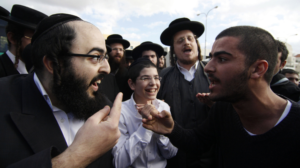 An ultra-Orthodox Jewish man (left) and a secular man argue during a protest against the strict religious codes favored by the ultra-Orthodox in the Israeli city of Beit Shemesh.