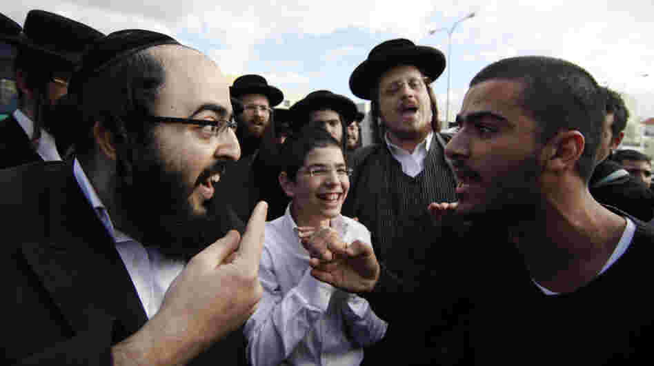 An ultra-Orthodox Jewish man (left) and a secular man argue during a protest against the strict religious codes favored by the ultra-Orthodox in the Israeli city of Beit Shemesh.