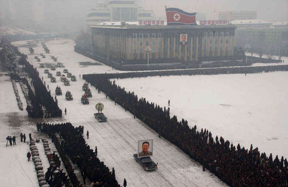 Hundreds of thousands of North Koreans line the route of Kim Jong Il's funeral cortege in snowfall as the late leader's body is driven through the streets of the capital Pyongyang. 