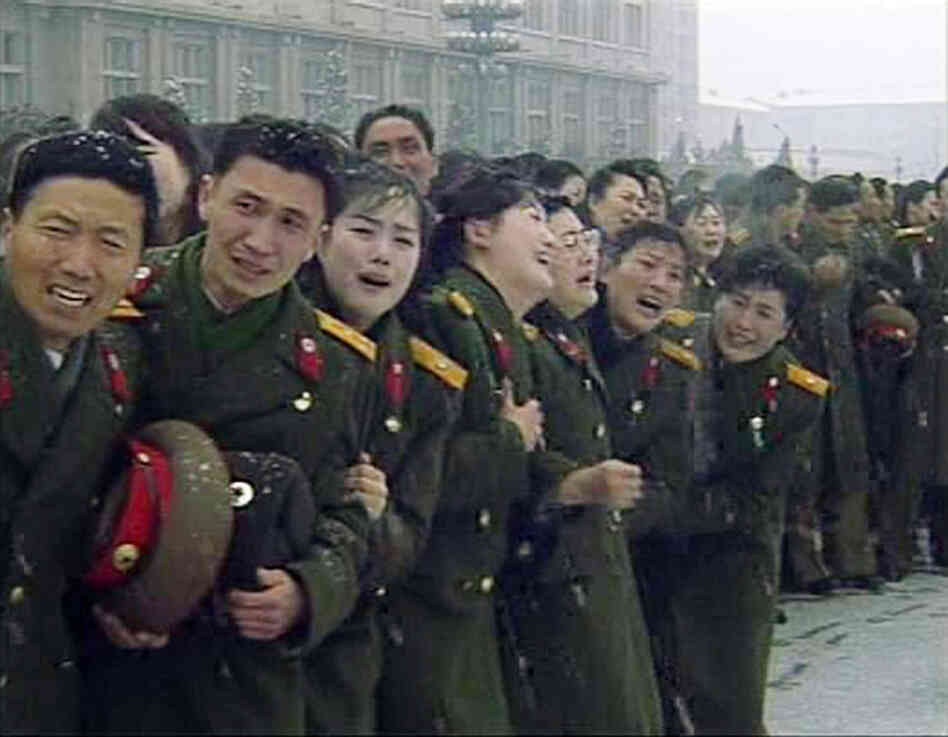 Military personnel react during Kim Jong Il's funeral procession in Pyongyang in this still image taken from video. 