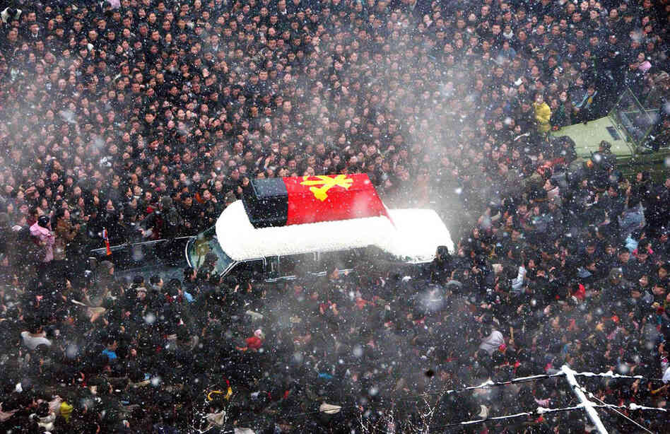 Mourners gather around a procession of a hearse carrying Kim Jong Il's body through the North Korean capital, Pyongyang. 