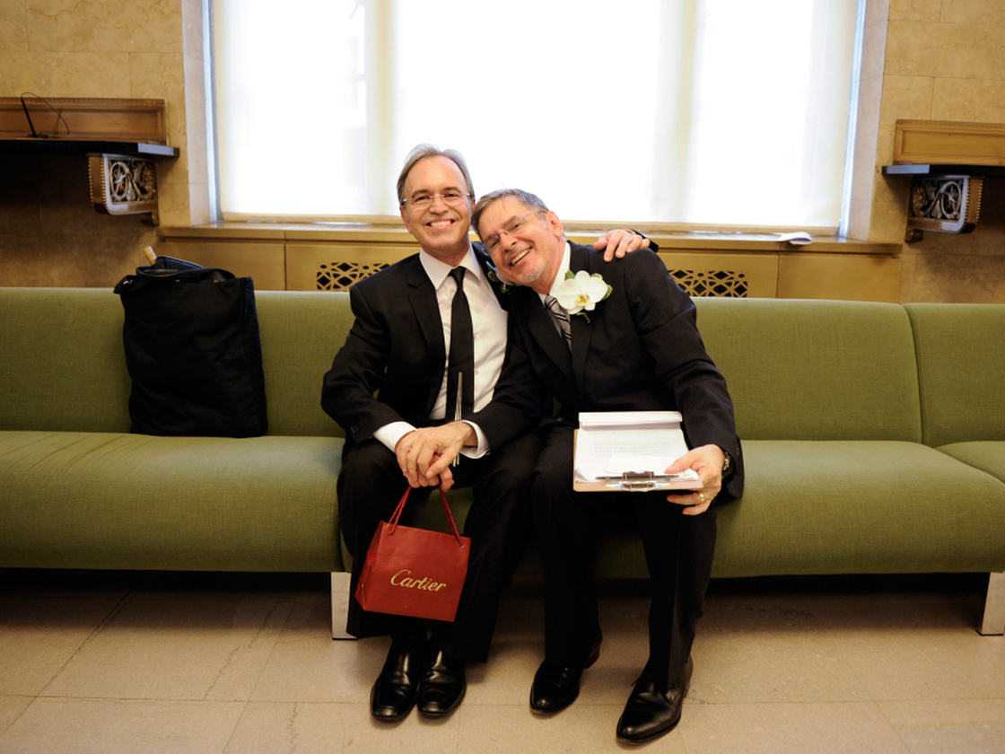 Same-sex couple Joseph and Jim pose for a photo as they wait to be officially married at the Manhattan City Clerk's Office on July 24, 2011, the first day gay couples were allowed to legally marry in New York. 