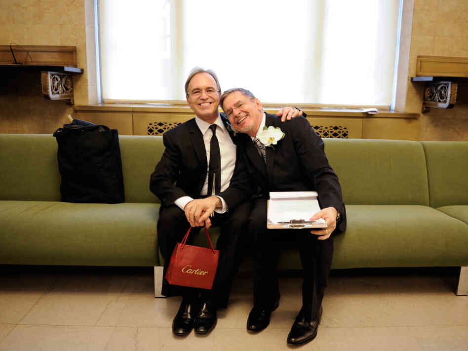 Same-sex couple Joseph and Jim pose for a photo as they wait to be officially married at the Manhattan City Clerk's Office on July 24, 2011, the first day gay couples were allowed to legally marry in New York. 