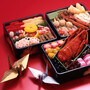 In Japan, the colorful New Year's meal is packaged in special, lacquered boxes. In Japan, the colorful New Year's meal is packaged in special, lacquered boxes.