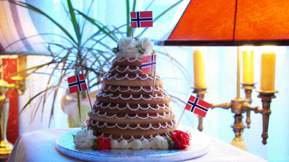 In Denmark they eat a towering cake called kransekage for New Year's Eve. Norwegians, who also eat it, call it kransekake. In Denmark they eat a towering cake called kransekage for New Year's Eve. Norwegians, who also eat it, call it kransekake.
