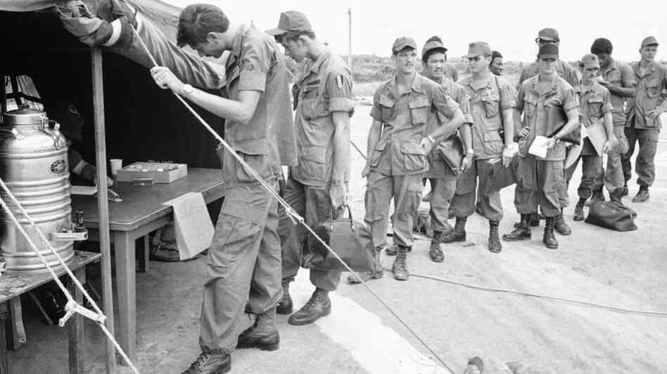 U.S. soldiers at Long Binh base, northeast of Saigon, line up to give urine samples at a heroin detection center in June 1971, before departing for the U.S. U.S. soldiers at Long Binh base, northeast of Saigon, line up to give urine samples at a heroin detection center in June 1971, before departing for the U.S.