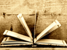 an open book in sepia colors and wooden background an open book in sepia colors and wooden background