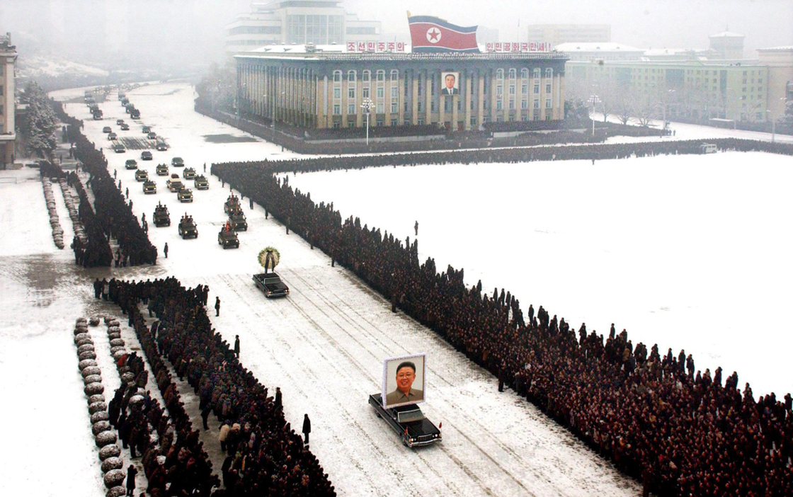 This image, released by the North Korean Central News Agency, was taken within seconds of the one above. An analysis shows that it was digitally altered, removing the cluster of men on the left edge and enhancing the perfect line of mourners.