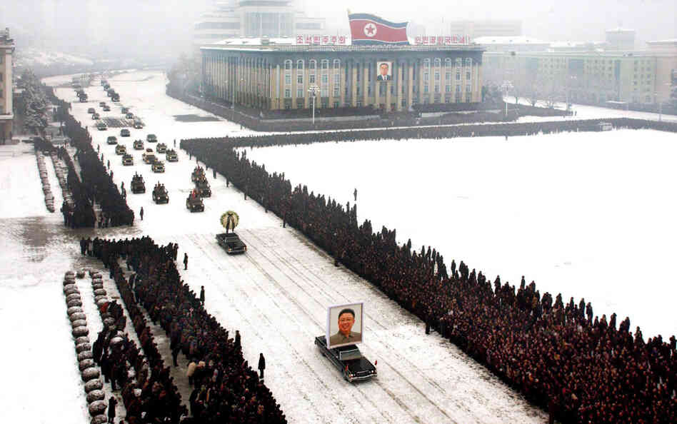 This image, released by the North Korean Central News Agency, was taken within seconds of the one above. An analysis shows that it was digitally altered, removing the cluster of men on the left edge and enhancing the perfect line of mourners.