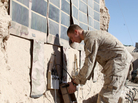 In this photo released by the U.S. Marines and taken in December 2010, Lance Cpl. Dakota Hicks, from Laharpe, Ill., connects a radio battery to a portable solar panel communication system in Sangin District, in Afghanistan.The U.S. military is trying to wean itself off reliance on fossil fuels by employing solar energy and biofuels, among other measures. In this photo released by the U.S. Marines and taken in December 2010, Lance Cpl. Dakota Hicks, from Laharpe, Ill., connects a radio battery to a portable solar panel communication system in Sangin District, in Afghanistan.The U.S. military is trying to wean itself off reliance on fossil fuels by employing solar energy and biofuels, among other measures.