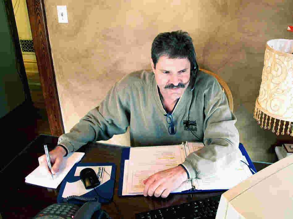 Randy Howland works in his small office in March, shortly after he began a work-from-home job with a call center earning $10 an hour. 