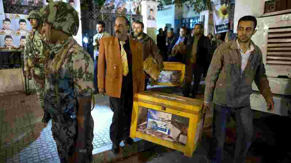 Egypt is holding parliamentary elections, but the military remains the most powerful force in the country. Here, election officials take away ballot boxes from a polling station in Cairo on Nov. 29, 2011. 