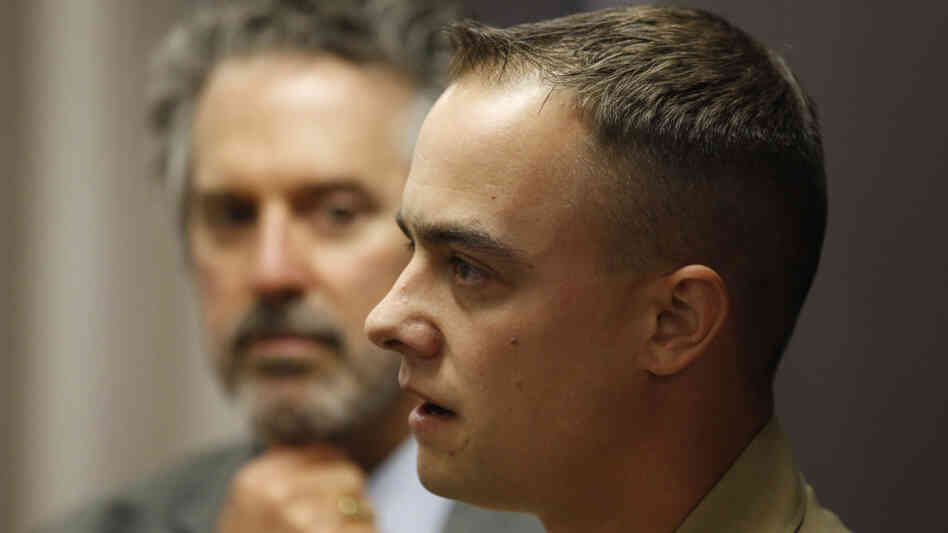 Marine Staff Sgt. Frank Wuterich talks to the media as his attorney, Neal Puckett, looks on after a 2010 pretrial hearing at Camp Pendleton in California. Wuterich is charged with voluntary manslaughter in the deaths of 24 Iraqi civilians in 2005.