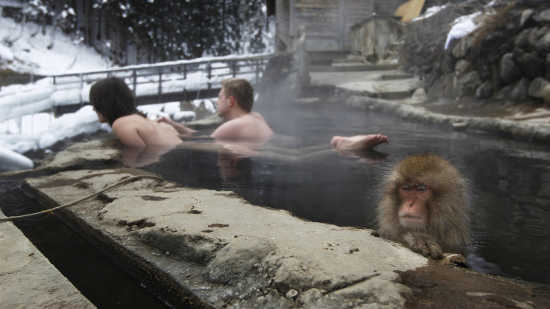 A couple from the Czech Republic bathe with a macaque in Nagano, central Japan, in January. 