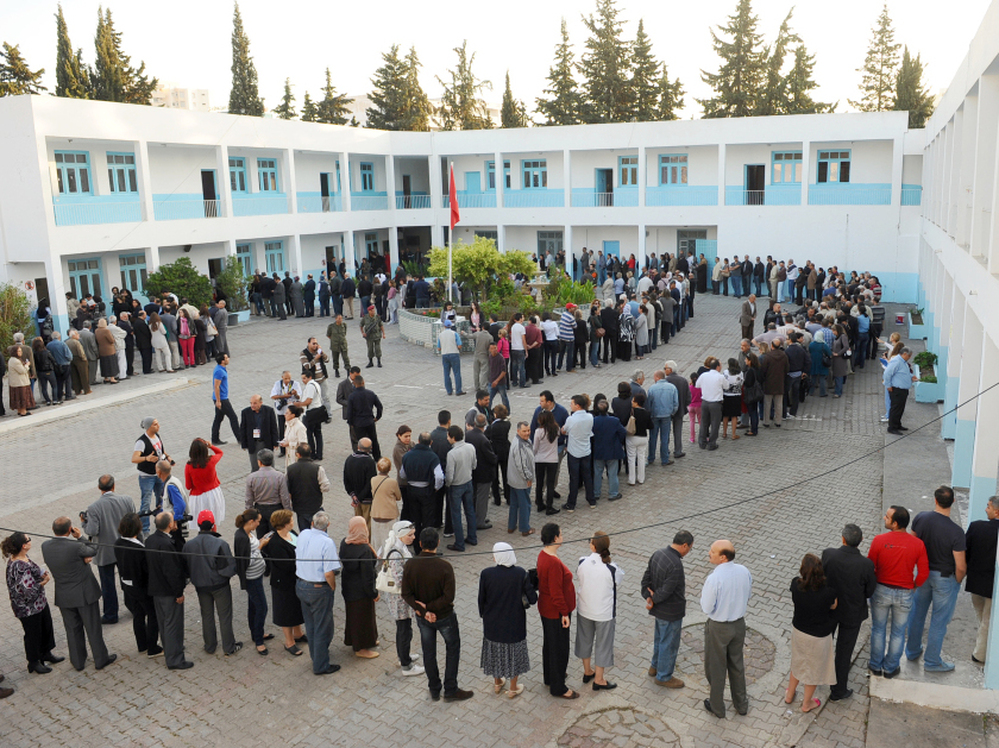Tunisians have elected an assembly to write a new constitution. Voters are shown here on Oct. 23, 2011, outside a polling station in the capital Tunis. 