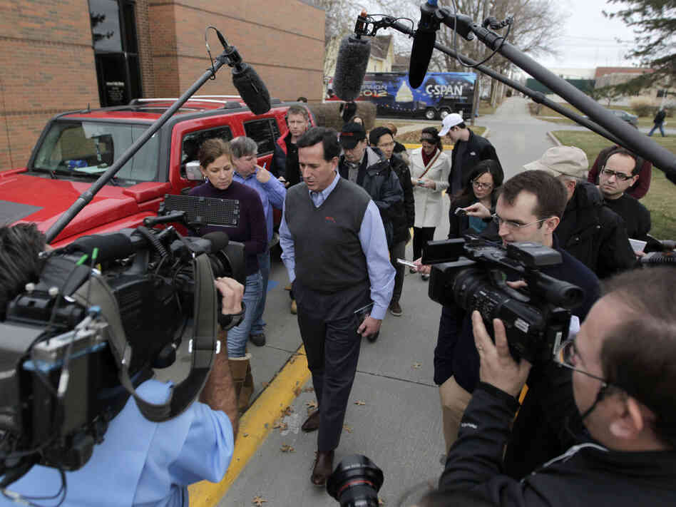 Rick Santorum with news media after a campaign stop in Indianola, Iowa.