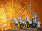 Fireworks explode over the Quadriga statue atop the Brandenburg Gate on New Year's Eve on January 1, 2012 in Berlin, Germany. Fireworks explode over the Quadriga statue atop the Brandenburg Gate on New Year's Eve on January 1, 2012 in Berlin, Germany.