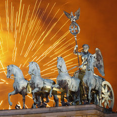 Fireworks explode over the Quadriga statue atop the Brandenburg Gate on New Year's Eve on January 1, 2012 in Berlin, Germany.