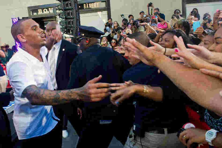 Singer Chris Brown meets with fans after performing on NBC's Today show in New York in July. Two years after his arrest for assaulting his then-girlfriend Rihanna, many of his fans — mostly teenage girls — blame Rihanna for the incident. Singer Chris Brown meets with fans after performing on NBC's Today show in New York in July. Two years after his arrest for assaulting his then-girlfriend Rihanna, many of his fans — mostly teenage girls — blame Rihanna for the incident.