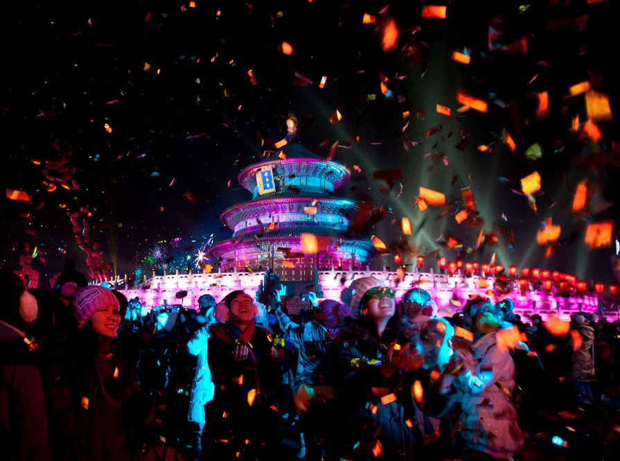 Visitors are  showered by confetti during a light show at the Temple of Heaven in Beijing Jan. 1. 