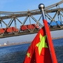 Trucks loaded with Chinese goods head across the Yalu Bridge and into North Korea one day after the memorial service for the late leader Kim Jong Il, at the Chinese North Korean border town of Dandong on December 30, 2011. 