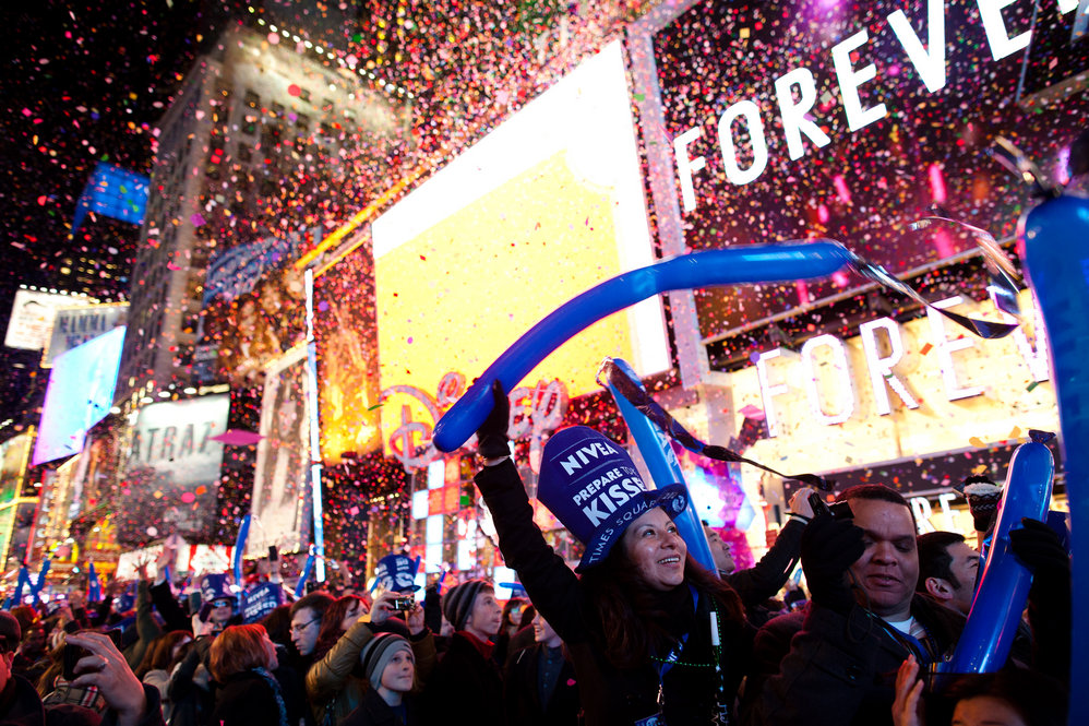 Revelers cheer at midnight in Times Square in New York. Some began camping out Saturday morning. 