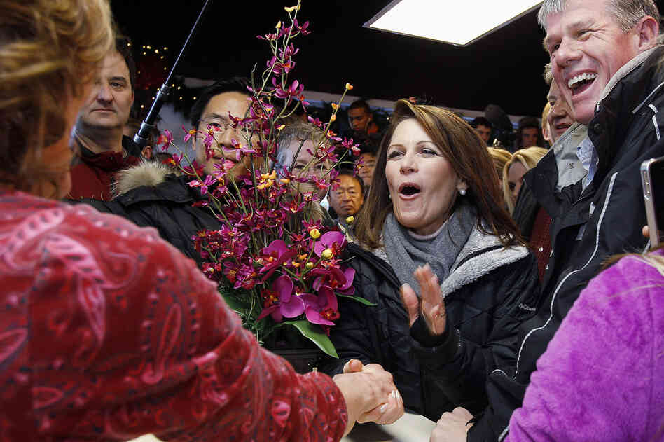 Rep. Michele Bachmann shakes hands with a store owner during a campaign stop Monday in West Des Moines, Iowa. 