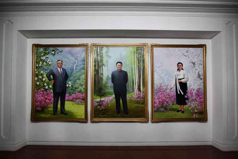 Portraits of Kim Il Sung (left) and Kim Jong Il (center) are seen inside a government building.