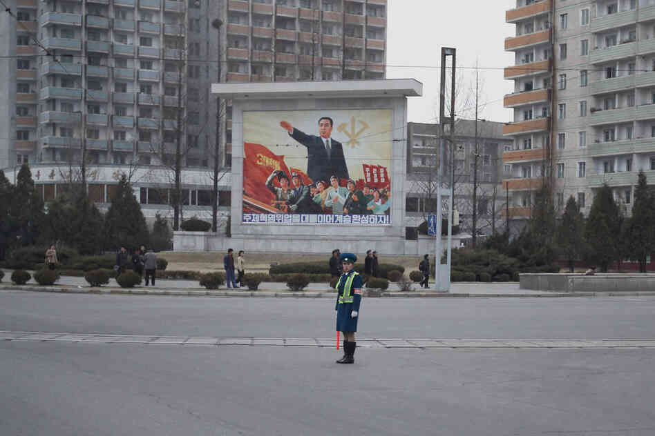 A young policewoman directs traffic.
