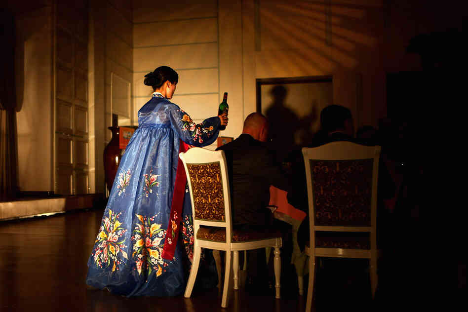 Waitresses distribute drinks and food.
