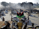 A rebel fighter stands on a monument inside Moammar Gadhafi's main compound in Tripoli. A rebel fighter stands on a monument inside Moammar Gadhafi's main compound in Tripoli.