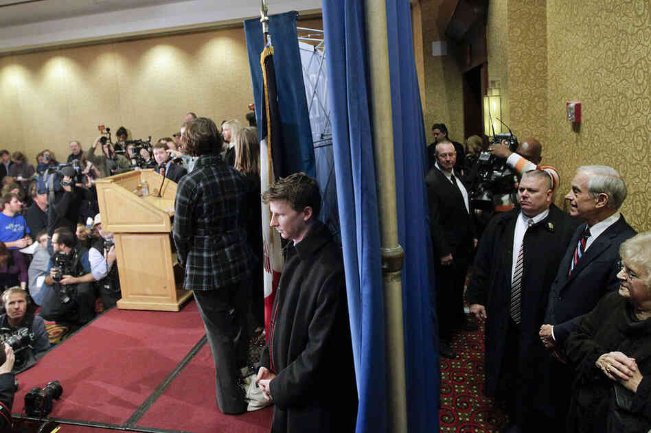 Rep. Ron Paul of Texas waits with his wife Carol, and others, prior to speaking at a campaign stop in Des Moines, Iowa. 