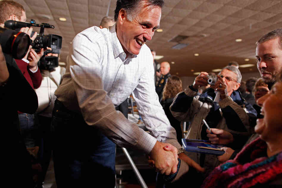 Mitt Romney greets supporters and gives autographs during a rally at the Mississippi Valley Fairgrounds Monday in Davenport, Iowa.  