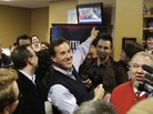Republican presidential candidate Rick Santorum points to a television showing his campaign stop on live at the Daily Grind coffee shop in Sioux City, Iowa, Sunday. Republican presidential candidate Rick Santorum points to a television showing his campaign stop on live at the Daily Grind coffee shop in Sioux City, Iowa, Sunday.