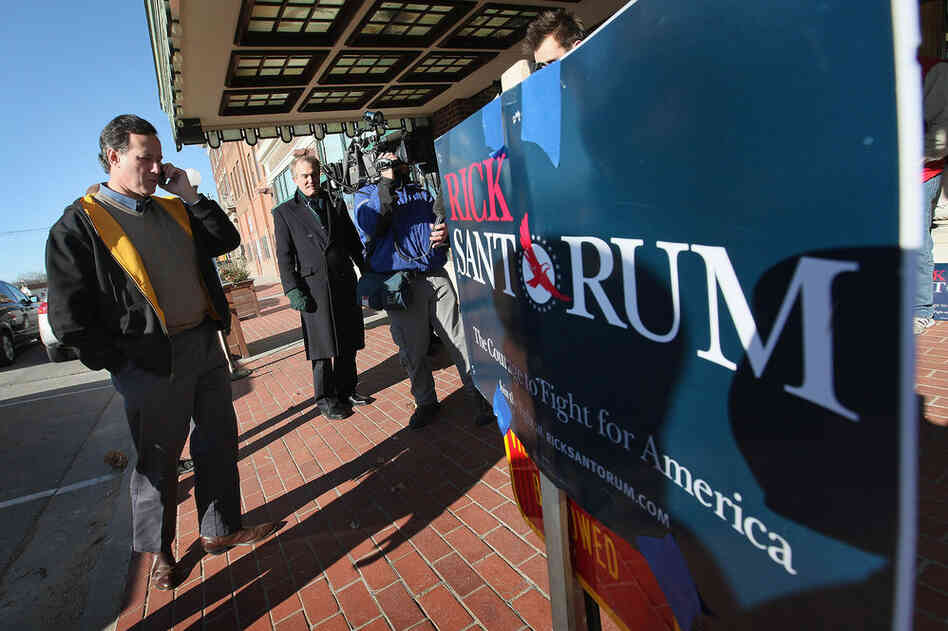 Former U.S. Senator Rick Santorum arrives for a campaign rally at the Hotel Pattee Monday in Perry, Iowa. 