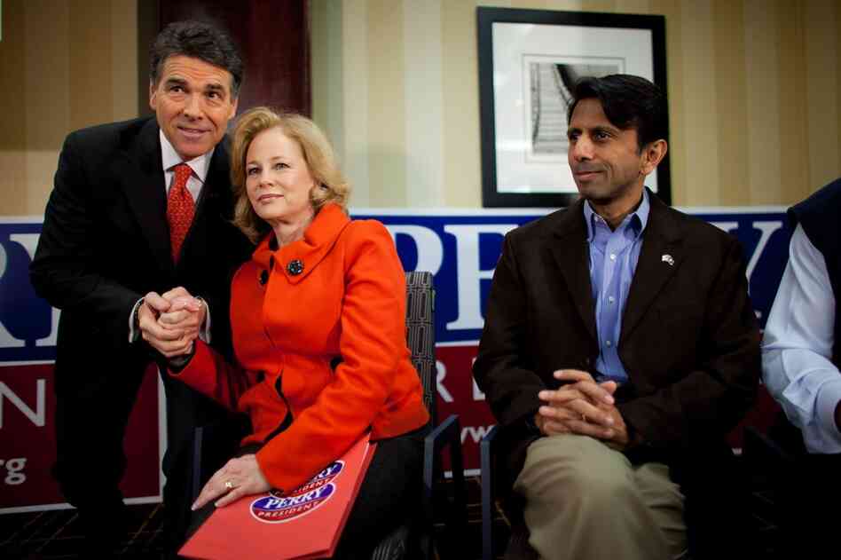 Rick Perry and his wife, Anita, before speaking to voters in West Des Moines. At right is Louisiana Gov. Bobby Jindal. 
