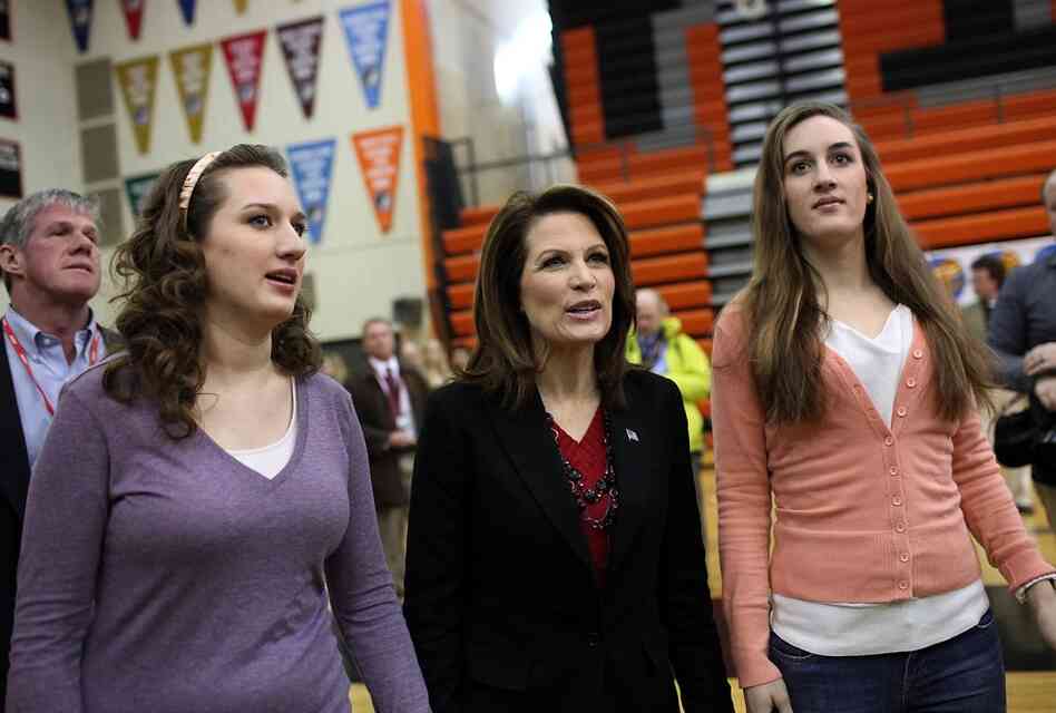 Michele Bachmann walks with her daughters Caroline (right) and Elise before an event at Valley High School in West Des Moines. 