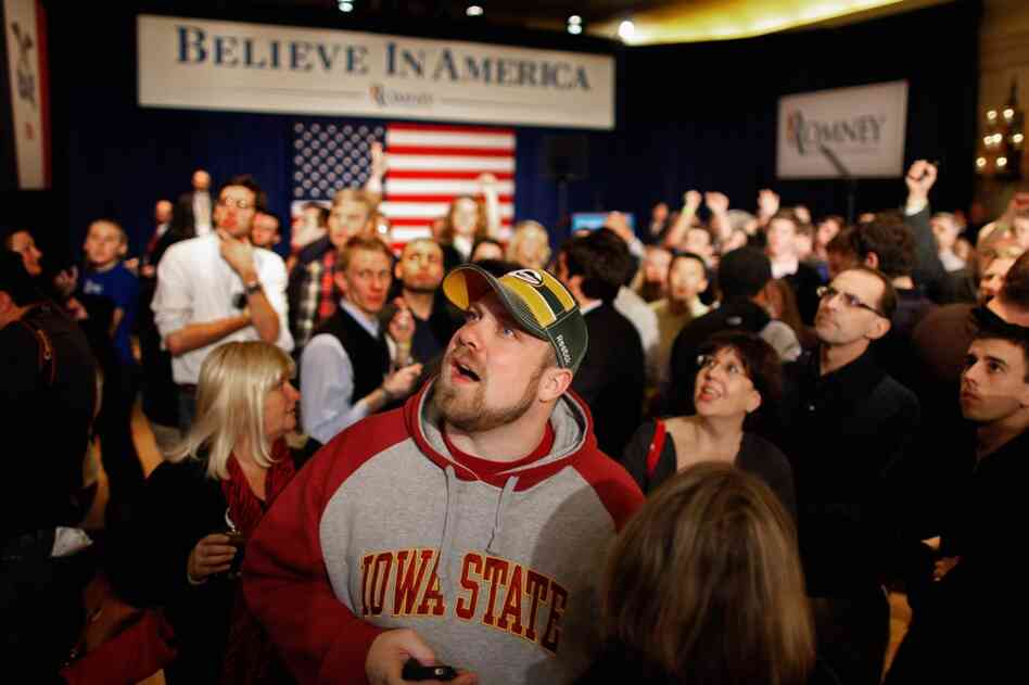 Supporters and volunteers watch caucus results during a rally for Mitt Romney in Des Moines. 