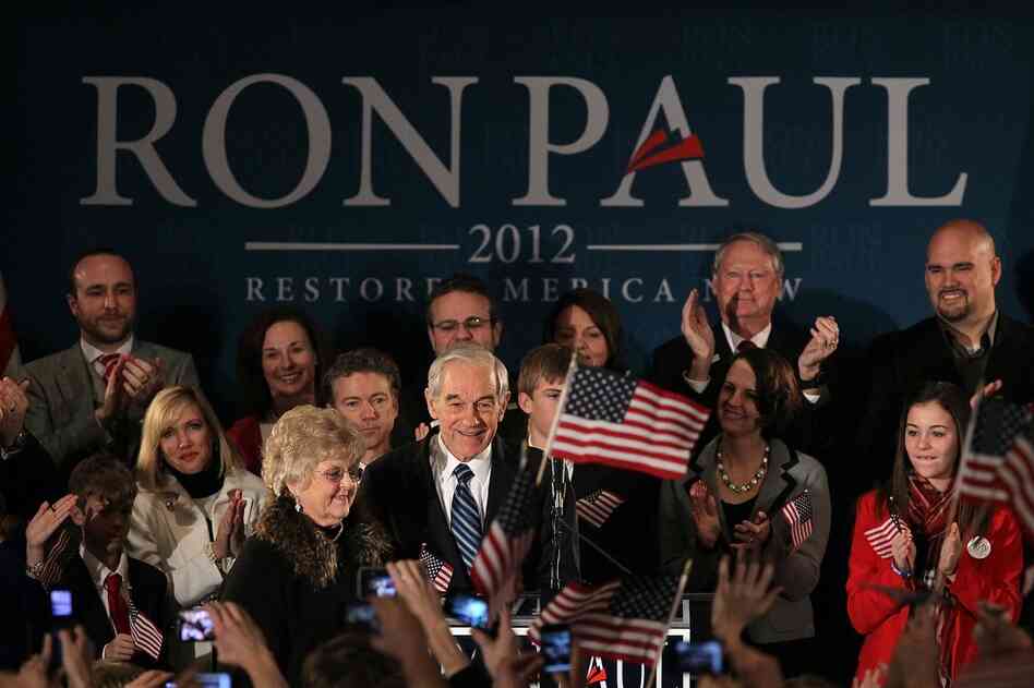 Ron Paul (center) and his wife, Carol, greet supporters during a rally in Ankeny. 